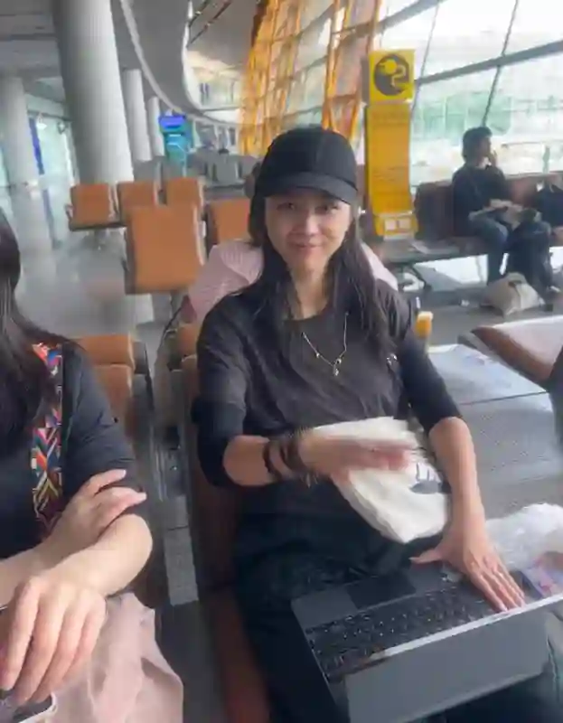 46岁汤唯在北京机场，坐大厅候机很随和，素颜眼镜耷拉皱纹明显