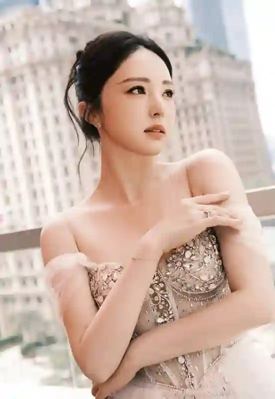 董璇泳池畔饮椰水笑容灿烂，一袭礼裙勾勒曼妙身姿尽显惬意